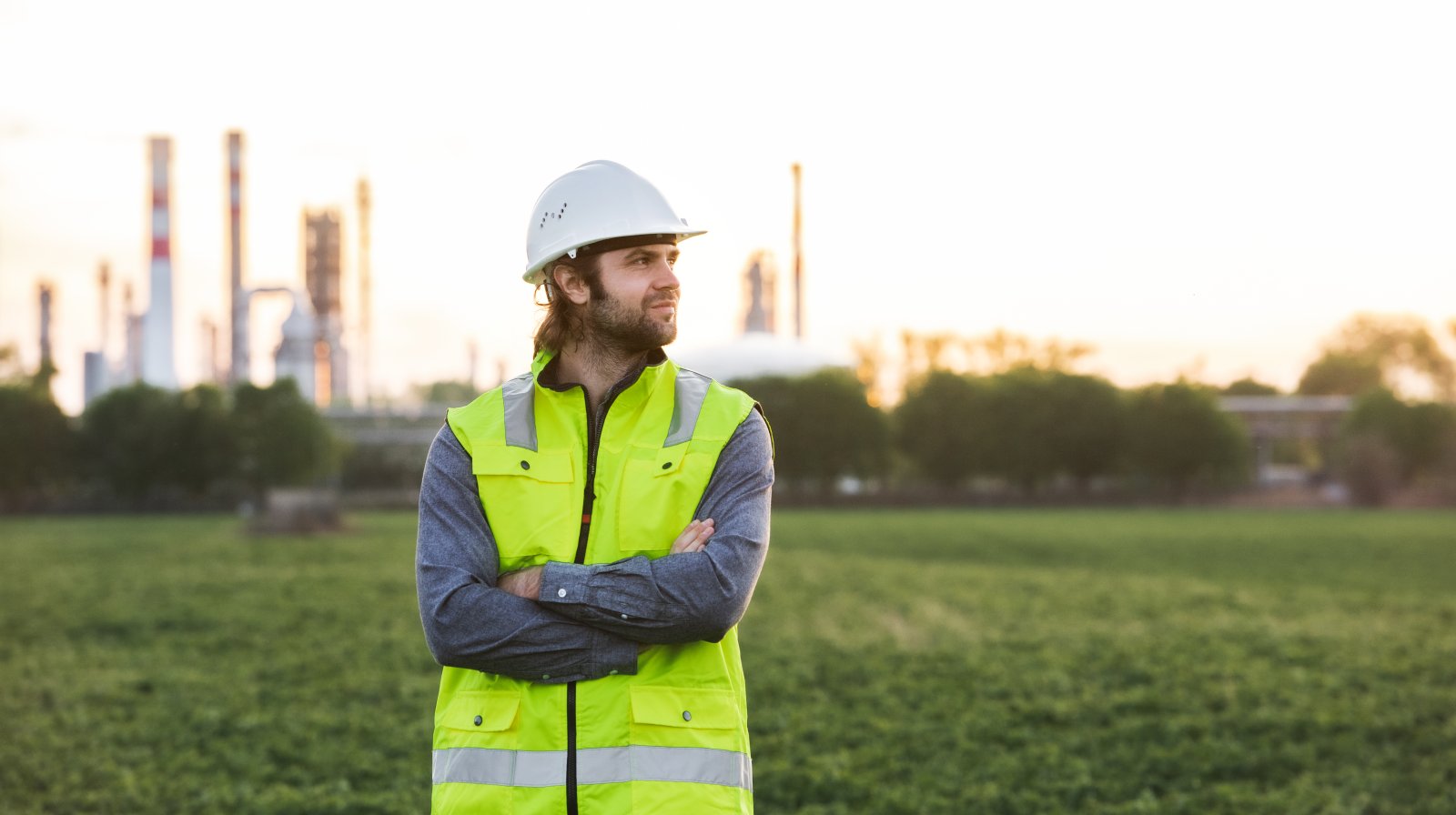young-engineer-standing-outdoors-by-oil-refinery-2024-10-18-23-12-22-utc